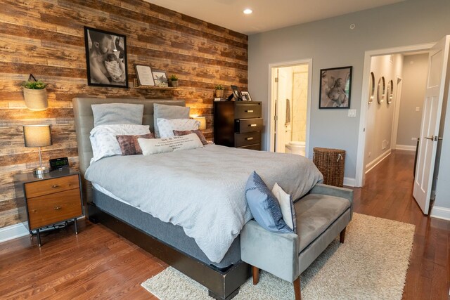 1009 Lathrop Ave, Forest Park, IL 60130 - bedroom featuring wooden walls, baseboards, wood finished floors, recessed lighting, and connected bathroom
