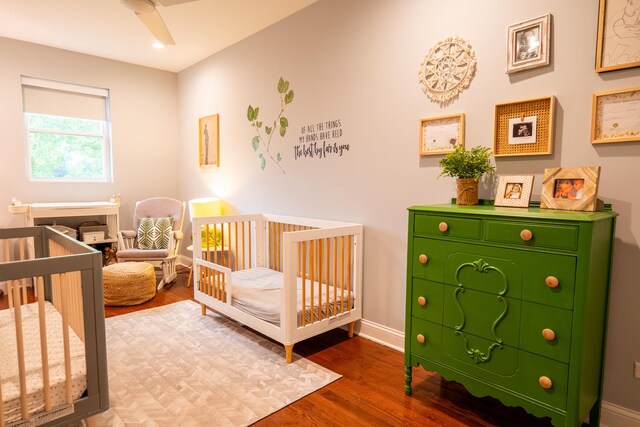 1009 Lathrop Ave, Forest Park, IL 60130 - bedroom featuring wood finished floors, baseboards, and a crib
