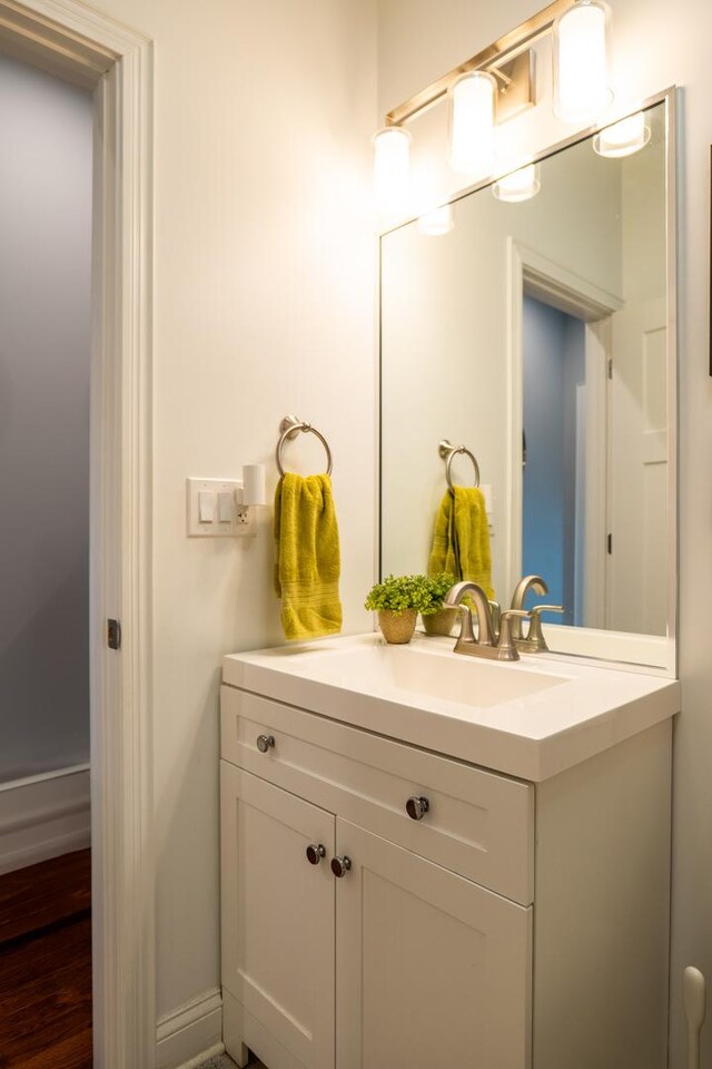 1009 Lathrop Ave, Forest Park, IL 60130 - bathroom featuring vanity, wood finished floors, and baseboards