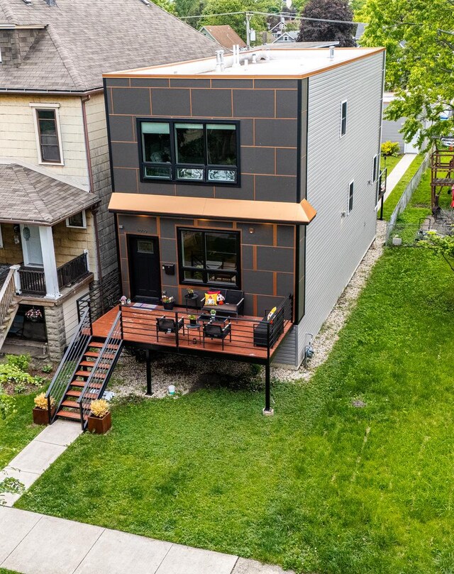 1009 Lathrop Ave, Forest Park, IL 60130 - rear view of house featuring a lawn, roof with shingles, stairway, and a deck