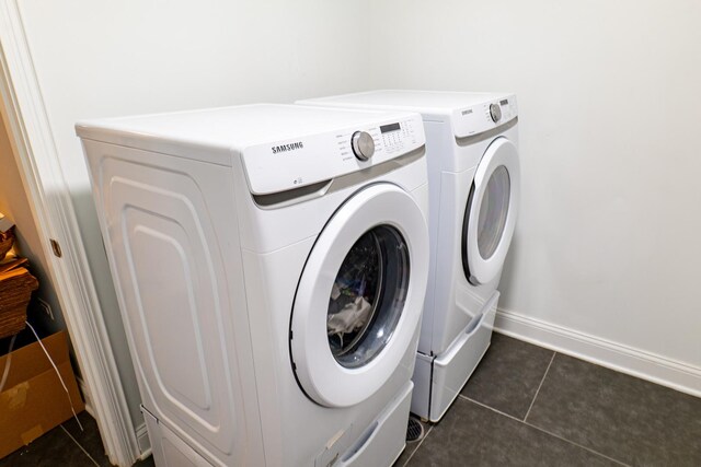 1009 Lathrop Ave, Forest Park, IL 60130 - washroom with washer and clothes dryer, dark tile patterned floors, and baseboards