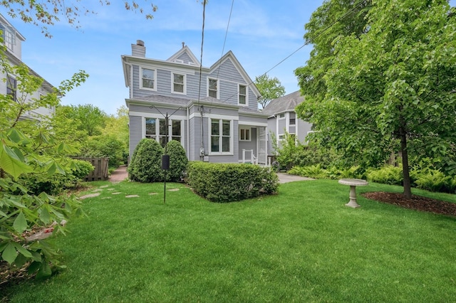641 Michigan Ave, Evanston, IL 60202 - rear view of property featuring a chimney and a lawn