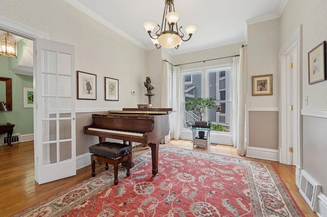 641 Michigan Ave, Evanston, IL 60202 - living area with a chandelier, wood finished floors, crown molding, and baseboards