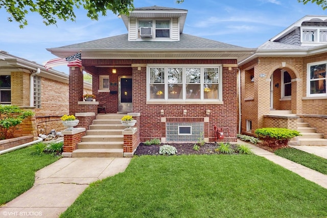 6250 W Holbrook St, Chicago, IL 60646 - view of front facade featuring a front yard, brick siding, a shingled roof, and covered porch