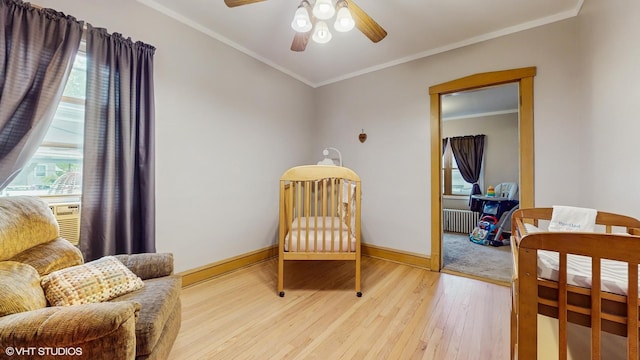 6250 W Holbrook St, Chicago, IL 60646 - bedroom featuring radiator, light wood-style floors, baseboards, ornamental molding, and ceiling fan