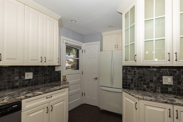 5940 W 88th Pl, Oak Lawn, IL 60453 - kitchen with freestanding refrigerator, stainless steel dishwasher, tasteful backsplash, glass insert cabinets, and dark stone counters