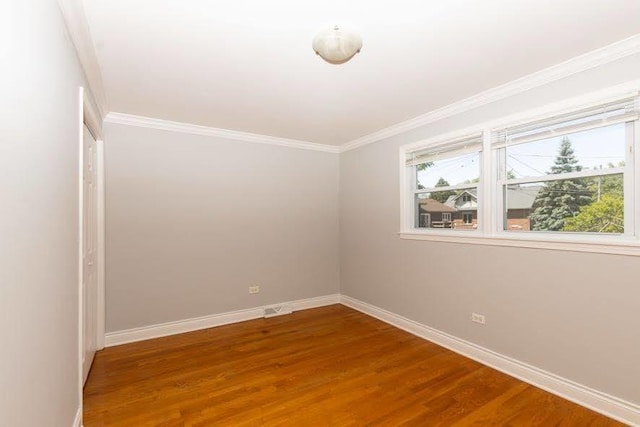 5940 W 88th Pl, Oak Lawn, IL 60453 - spare room featuring baseboards, wood finished floors, and crown molding