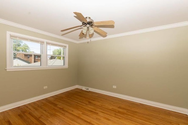 5940 W 88th Pl, Oak Lawn, IL 60453 - unfurnished room with baseboards, wood finished floors, crown molding, and a ceiling fan