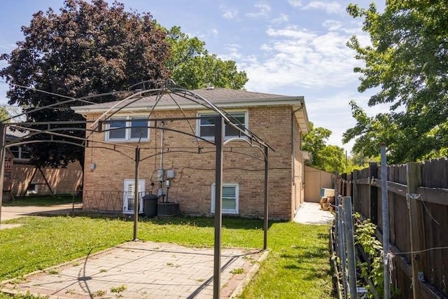 5940 W 88th Pl, Oak Lawn, IL 60453 - back of property with brick siding, a patio area, and cooling unit