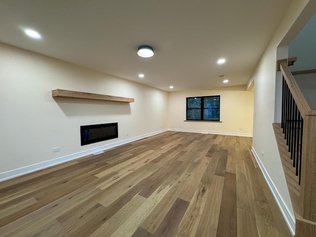 6013 Perry Dr, Woodridge, IL 60517 - unfurnished living room with wood finished floors, stairway, a glass covered fireplace, recessed lighting, and baseboards
