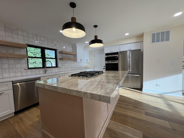 6013 Perry Dr, Woodridge, IL 60517 - kitchen with appliances with stainless steel finishes, open shelves, a sink, a center island, and decorative backsplash