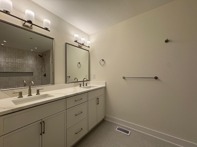 6013 Perry Dr, Woodridge, IL 60517 - bathroom with double vanity, tiled shower, baseboards, and tile patterned floors