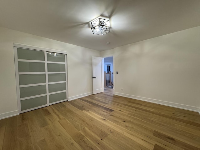 6013 Perry Dr, Woodridge, IL 60517 - empty room featuring hardwood / wood-style flooring and baseboards