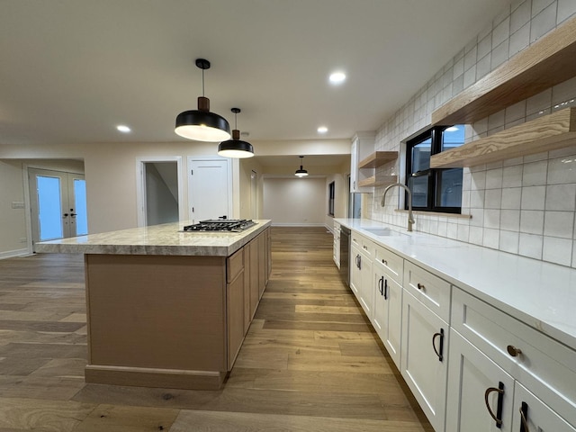 6013 Perry Dr, Woodridge, IL 60517 - kitchen featuring open shelves, a sink, appliances with stainless steel finishes, a center island, and light wood-type flooring