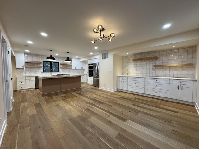 6013 Perry Dr, Woodridge, IL 60517 - kitchen with open shelves, tasteful backsplash, freestanding refrigerator, white cabinets, and recessed lighting