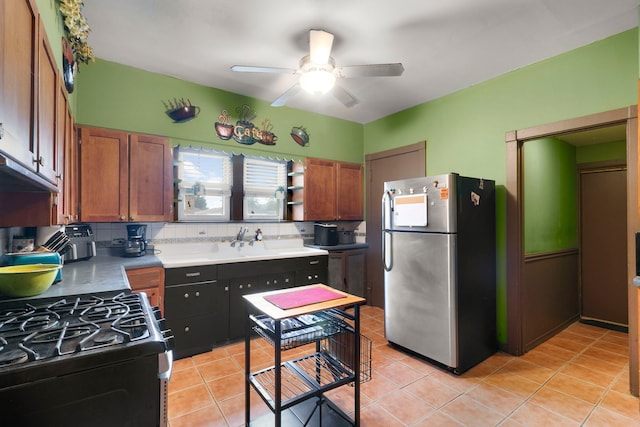 96 E Quincy St, Riverside, IL 60546 - kitchen featuring freestanding refrigerator, gas range, ceiling fan, a sink, and brown cabinets