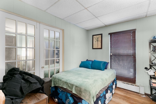 96 E Quincy St, Riverside, IL 60546 - bedroom with wood finished floors, a paneled ceiling, and a baseboard heating unit