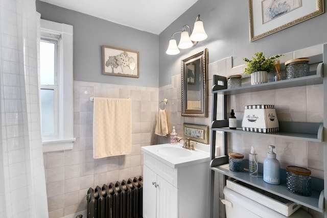 96 E Quincy St, Riverside, IL 60546 - bathroom with radiator, tile walls, vanity, and toilet