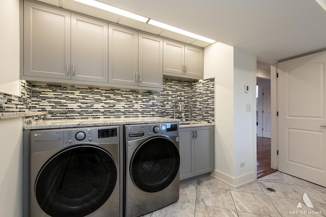 8519 S 82nd Ct, Hickory Hills, IL 60457 - laundry room with washing machine and dryer, cabinet space, baseboards, and light tile patterned floors