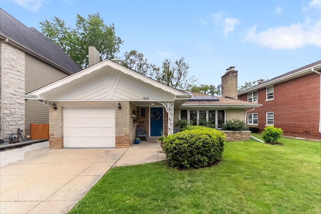 464 Northgate Ct, Riverside, IL 60546 - view of front of home with brick siding, a chimney, roof mounted solar panels, and a front yard