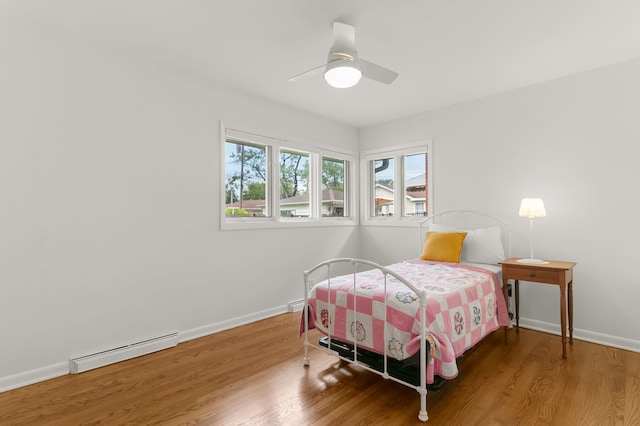 464 Northgate Ct, Riverside, IL 60546 - bedroom featuring baseboard heating, wood finished floors, baseboards, and a ceiling fan