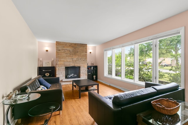 464 Northgate Ct, Riverside, IL 60546 - living area with light wood-type flooring, a stone fireplace, and a baseboard heating unit