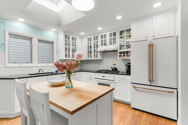 464 Northgate Ct, Riverside, IL 60546 - kitchen with white appliances, a sink, white cabinetry, light wood finished floors, and decorative backsplash