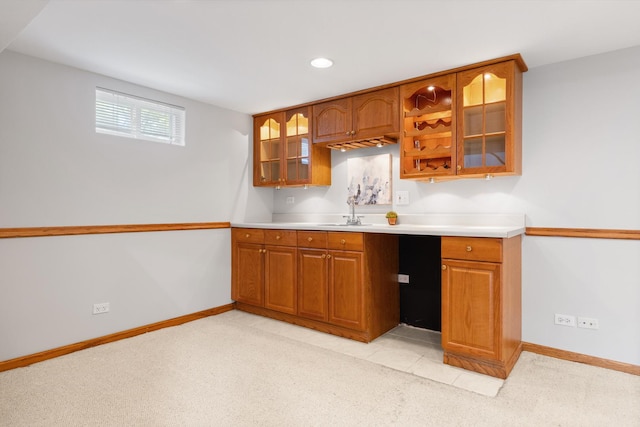 124 N W End Ave, Westmont, IL 60559 - kitchen with brown cabinetry, a sink, light colored carpet, baseboards, and recessed lighting