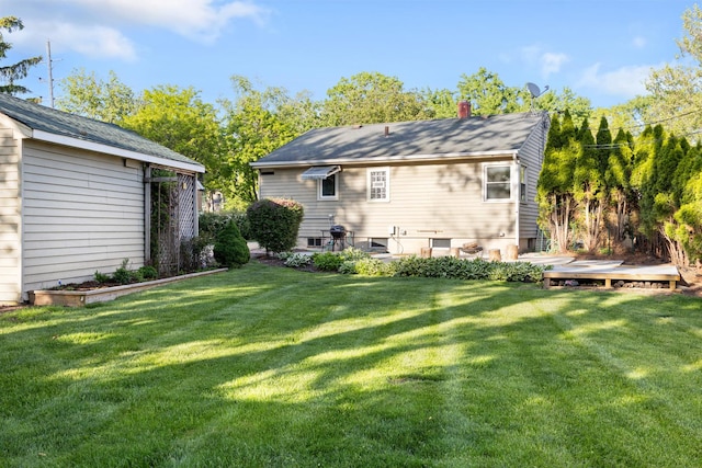 124 N W End Ave, Westmont, IL 60559 - back of house with a lawn, a deck, a chimney, and an outdoor structure