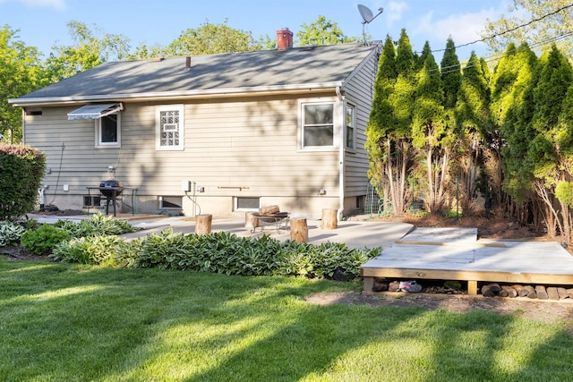 124 N W End Ave, Westmont, IL 60559 - rear view of house with a deck, a yard, a chimney, a patio area, and roof with shingles