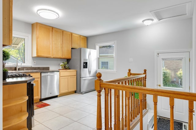 124 N W End Ave, Westmont, IL 60559 - kitchen featuring appliances with stainless steel finishes, a sink, dark countertops, open shelves, and plenty of natural light