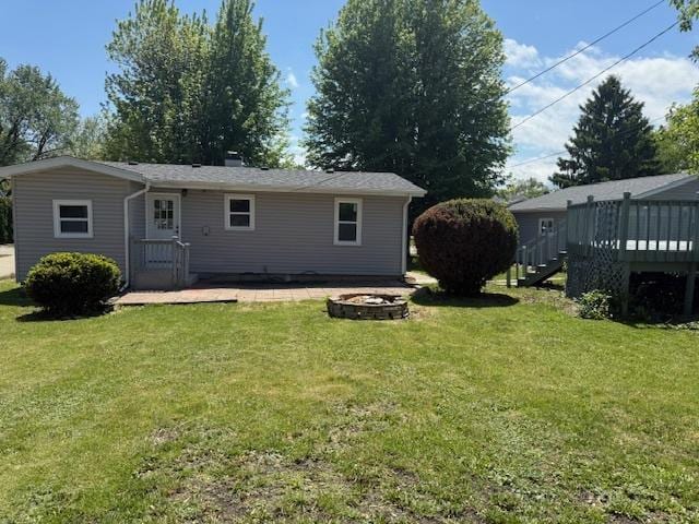 528 Ivy Ct, Round Lake Beach, IL 60073 - back of property with a fire pit, a deck, and a yard