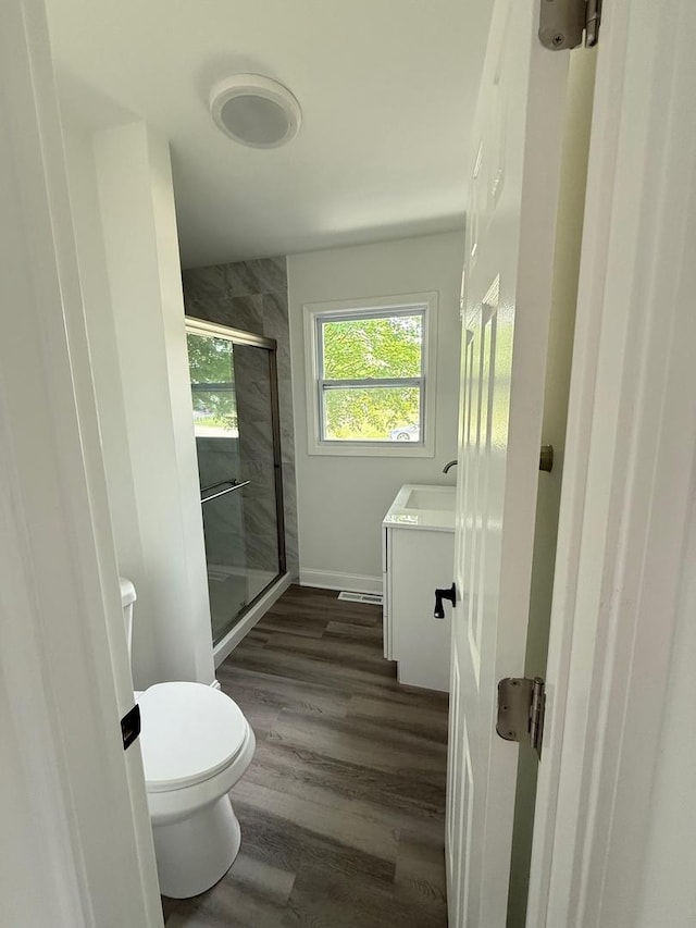 528 Ivy Ct, Round Lake Beach, IL 60073 - full bath with toilet, a stall shower, vanity, wood finished floors, and baseboards