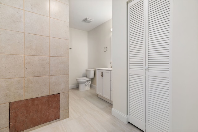 718 Sycamore St, Ottawa, IL 61350 - bathroom featuring vanity, toilet, a closet, and baseboards