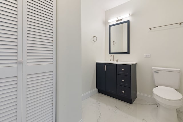 718 Sycamore St, Ottawa, IL 61350 - bathroom featuring baseboards, marble look tiles, vanity, and toilet