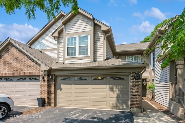 241 Old Oak Ct W, Buffalo Grove, IL 60089 - view of front facade with brick siding, driveway, and roof with shingles