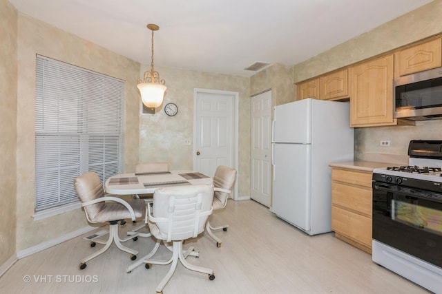241 Old Oak Ct W, Buffalo Grove, IL 60089 - kitchen with range with gas cooktop, stainless steel microwave, freestanding refrigerator, light brown cabinetry, and light wood-type flooring