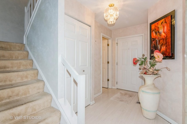 241 Old Oak Ct W, Buffalo Grove, IL 60089 - entryway with stairway, a chandelier, and baseboards