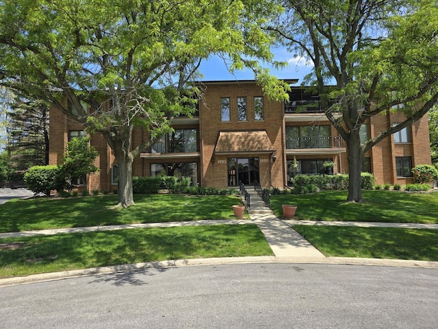 9906 Shady Ln Unit 1Sw, Orland Park, IL 60462 - view of front facade featuring brick siding, a front lawn, and a balcony