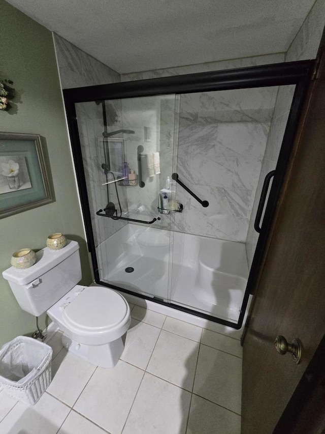 9906 Shady Ln Unit 1Sw, Orland Park, IL 60462 - bathroom featuring toilet, a shower stall, tile patterned floors, and a textured ceiling