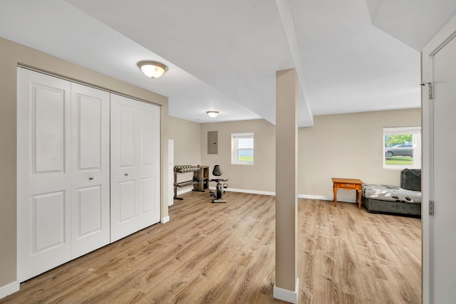 710 Sunset Ln, Shorewood, IL 60404 - exercise area with light wood-style floors, electric panel, and healthy amount of natural light