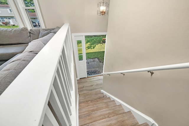 710 Sunset Ln, Shorewood, IL 60404 - stairway with wood finished floors, plenty of natural light, and a chandelier