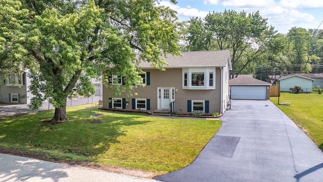 710 Sunset Ln, Shorewood, IL 60404 - raised ranch featuring a detached garage, an outbuilding, and a front lawn