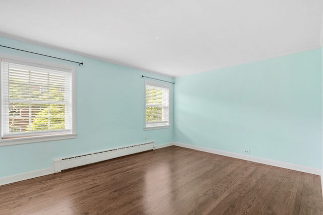 1412 Hinman Ave Unit 2W, Evanston, IL 60201 - unfurnished room with a baseboard heating unit, wood finished floors, and healthy amount of natural light