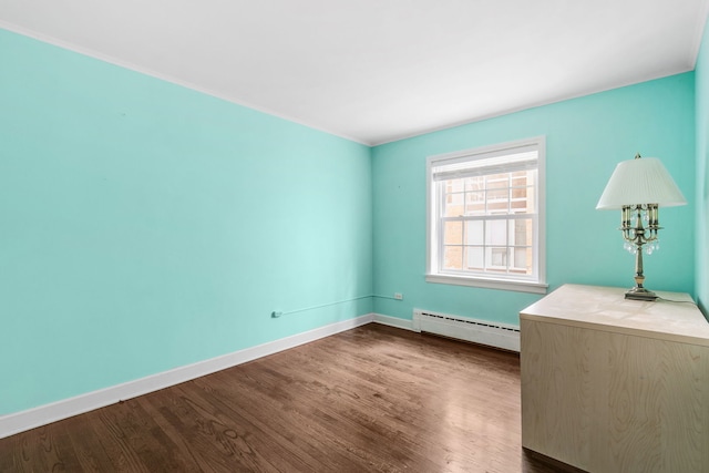 1412 Hinman Ave Unit 2W, Evanston, IL 60201 - unfurnished room featuring baseboard heating and dark wood finished floors