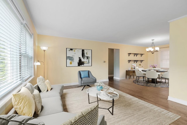 1412 Hinman Ave Unit 2W, Evanston, IL 60201 - living room with a chandelier, wood finished floors, and ornamental molding