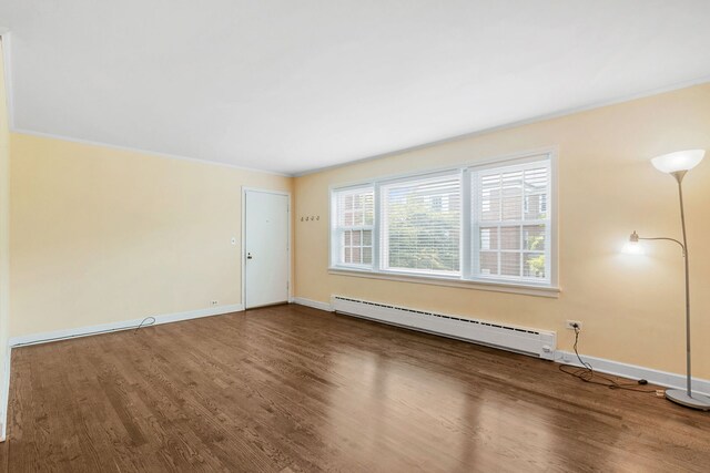 1412 Hinman Ave Unit 2W, Evanston, IL 60201 - unfurnished living room featuring a baseboard radiator, wood finished floors, and ornamental molding