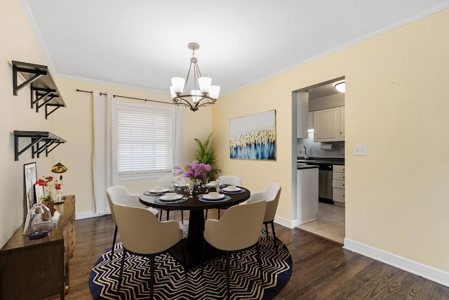 1412 Hinman Ave Unit 2W, Evanston, IL 60201 - dining area featuring a chandelier, dark wood finished floors, and ornamental molding