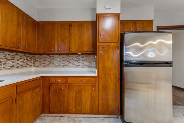 307 N Carico St, Tuscola, IL 61953 - kitchen featuring freestanding refrigerator, light countertops, and backsplash