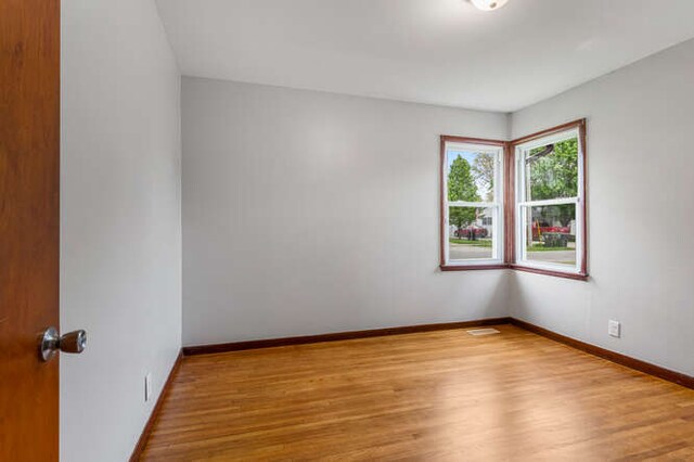 307 N Carico St, Tuscola, IL 61953 - empty room with wood finished floors and baseboards